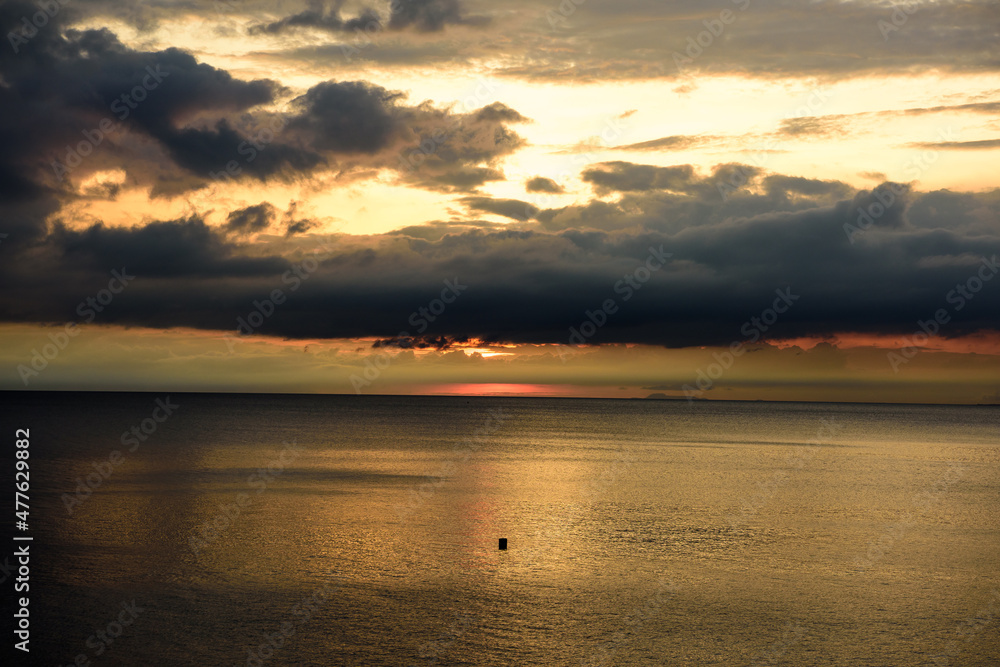 Panorama shots of gorgeous sunset over the Pacific Ocean with puffy rain clouds in the background. Panorama shots of gorgeous sunset over the Pacific Ocean with puffy rain clouds in the background.