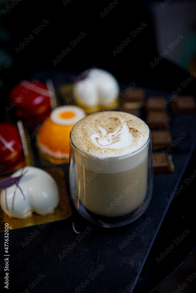 cappuccino, sweets (mousse cakes) and chocolate pieces. cappuccino, sweets (mousse cakes) and chocolate pieces.