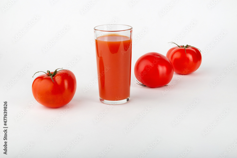 Tomato juice and fresh tomatoes on a white background. Tomato juice and fresh tomatoes on a white background.