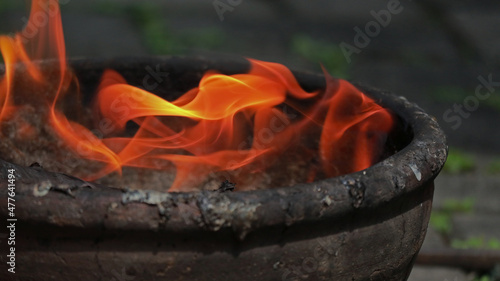 Fire burning in old mini bowl fireside.