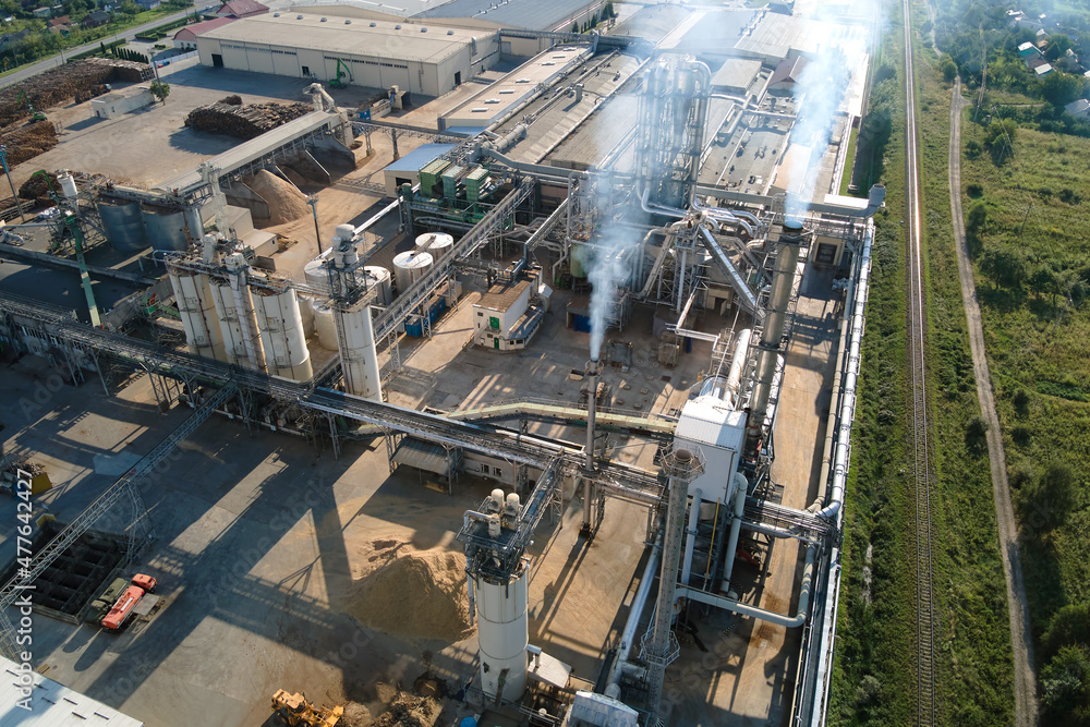 Aerial view of wood processing factory with stacks of lumber at plant manufacturing yard Aerial view of wood processing factory with stacks of lumber at plant manufacturing yard