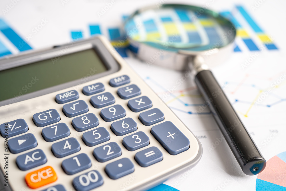 Magnifying glass on charts graphs paper. Financial development, Banking Account, Statistics, Investment Analytic research data economy, Stock exchange trading, Business office company meeting concept. Magnifying glass on charts graphs paper. Financial development, Banking Account, Statistics, Investment Analytic research data economy, Stock exchange trading, Business office company meeting concept.