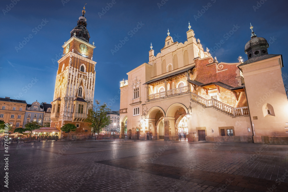 Fototapeta premium Town Hall Tower and Cloth Hall at Main Market Square at night - Krakow, Poland