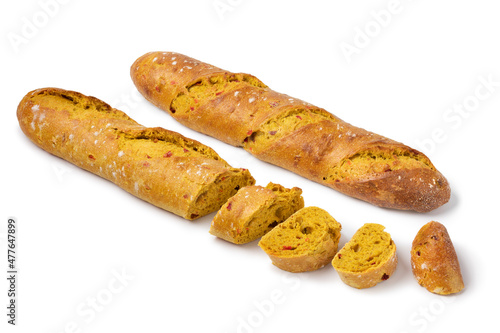  Fresh baked homemade baguette and slices with curry and tomato seasoning isolated on white background