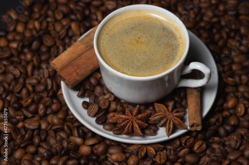 A cup of espresso coffee with cinnamon  coffee beans around. Natural coffee with additives. Invigorating drink