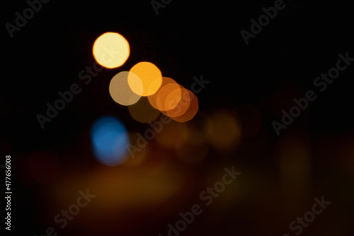 street lights in blurred focus. mix of orange, blue, yellow color