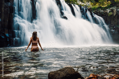 Rochester Falls and woman in bikini. Amazing cascade waterfall at Mauritius