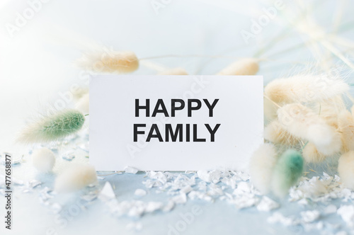 Happy family text on the card in the background fluffy branches of dried flower