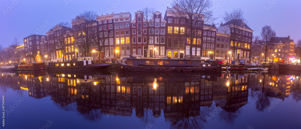 Panorama of the city waterfront of Amsterdam at sunset.