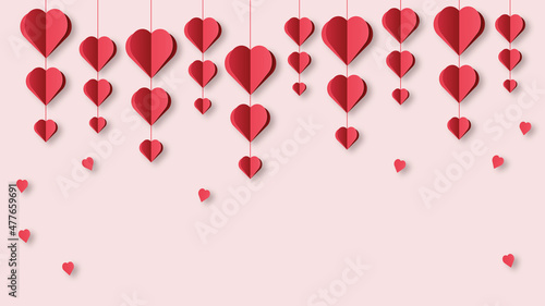 Red paper hearts hang on strings on a light background. Valentine