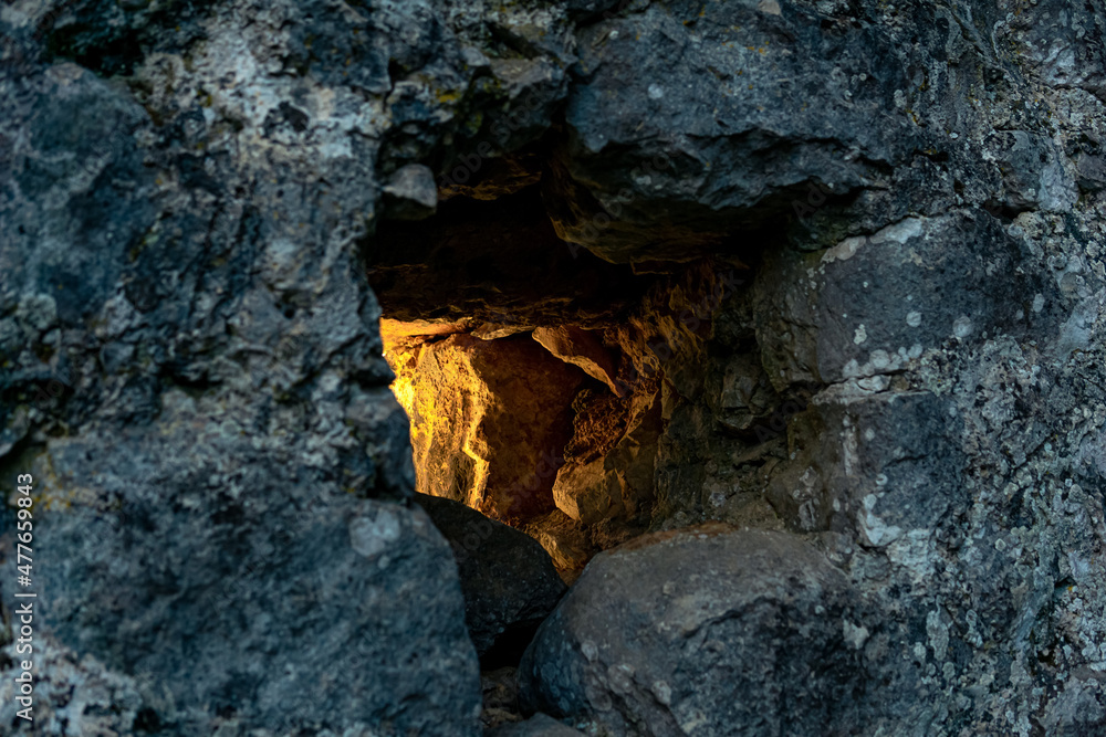 embrasure in the old fortress wall through which light breaks, close-up embrasure in the old fortress wall through which light breaks, close-up