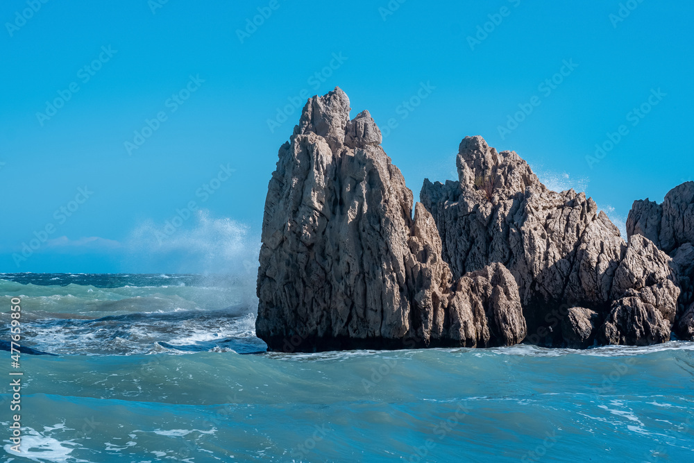sea coastal cliffs among surf on a windy sunny day sea coastal cliffs among surf on a windy sunny day