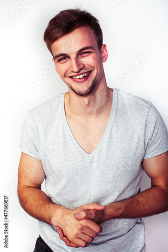 young handsome teenage hipster guy posing emotional, happy smiling against white background isolated, lifestyle people concept