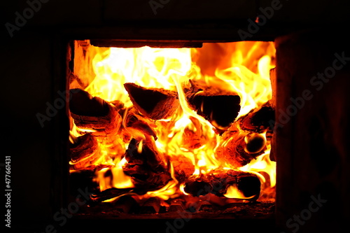A fire burns in a fireplace. Firewood burns with an open fire in the furnace