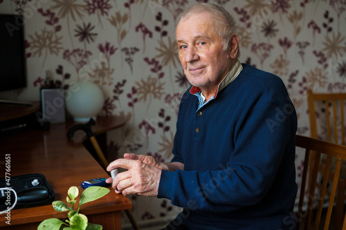 Senior man with lancet device
