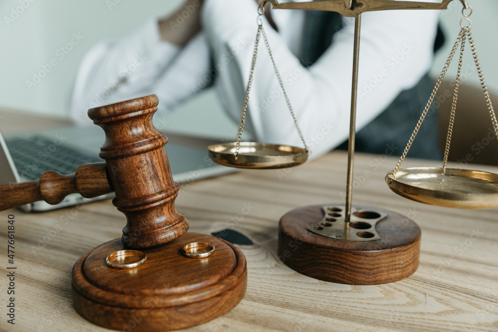 Divorce concept. Judge gavel and wedding rings. Top view