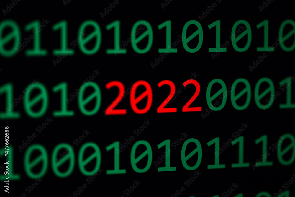 Close up of Binary codes on screen and 2022 word in the middle - New Year 2022 - Business concept