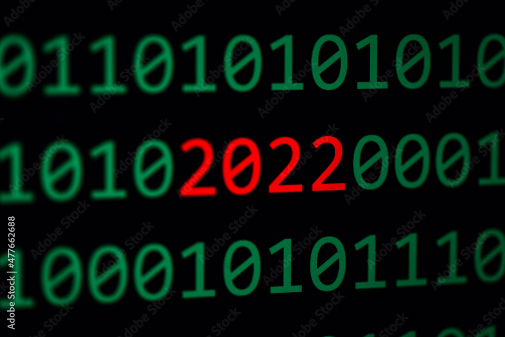 Close up of Binary codes on screen and 2022 word in the middle - New Year 2022 - Business concept Close up of Binary codes on screen and 2022 word in the middle - New Year 2022 - Business concept