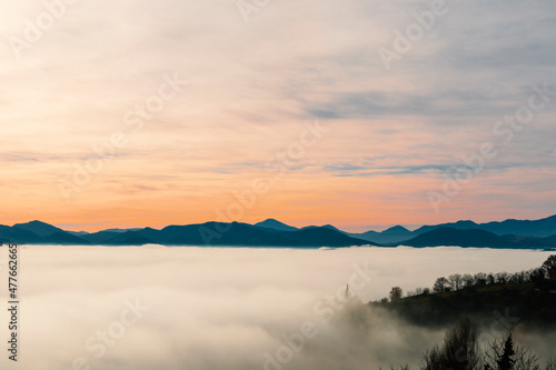Landscape at dusk, fog in the valley