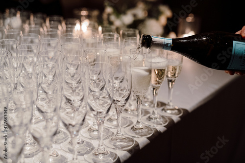 Pouring Champagne into Champagne Glasses at a Party