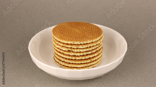 Dutch waffles in a white plate on a gray background