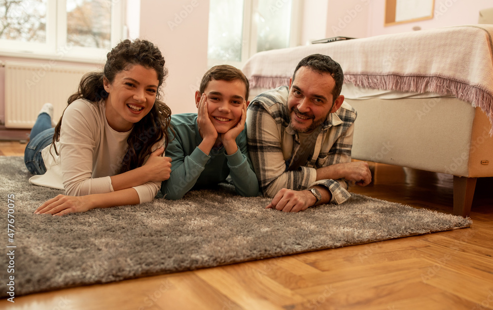 Happy family posing on floor at home