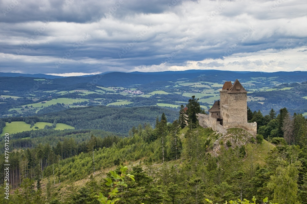 The photo was taken in the middle of summer 2021. It shows views of the medieval castle Kašperk. This castle stands in the middle of the Sumava Mountains.