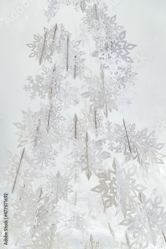 Decoration of paper white snowflakes in the form of a Christmas tree