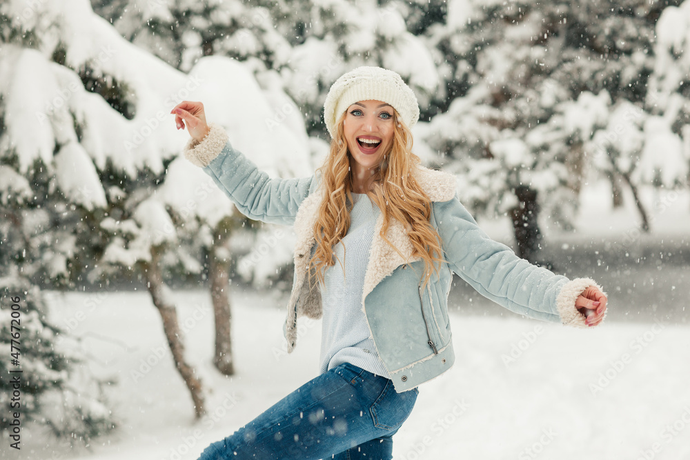 Young beautiful blonde woman in a snowy forest Young beautiful blonde woman in a snowy forest