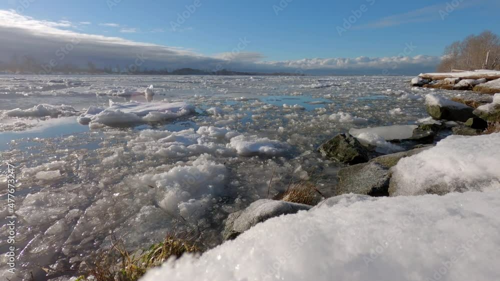 Fraser River Ice Floe Sunshine 4K UHD. Ice flowing down the Fraser River in winter. Richmond, British Columbia, Canada. Timelapse. 4K, UHD.
Fraser River Ice Floe Sunshine 4K UHD. Ice flowing down the Fraser River in winter. Richmond, British Columbia, Canada. Timelapse. 4K, UHD.