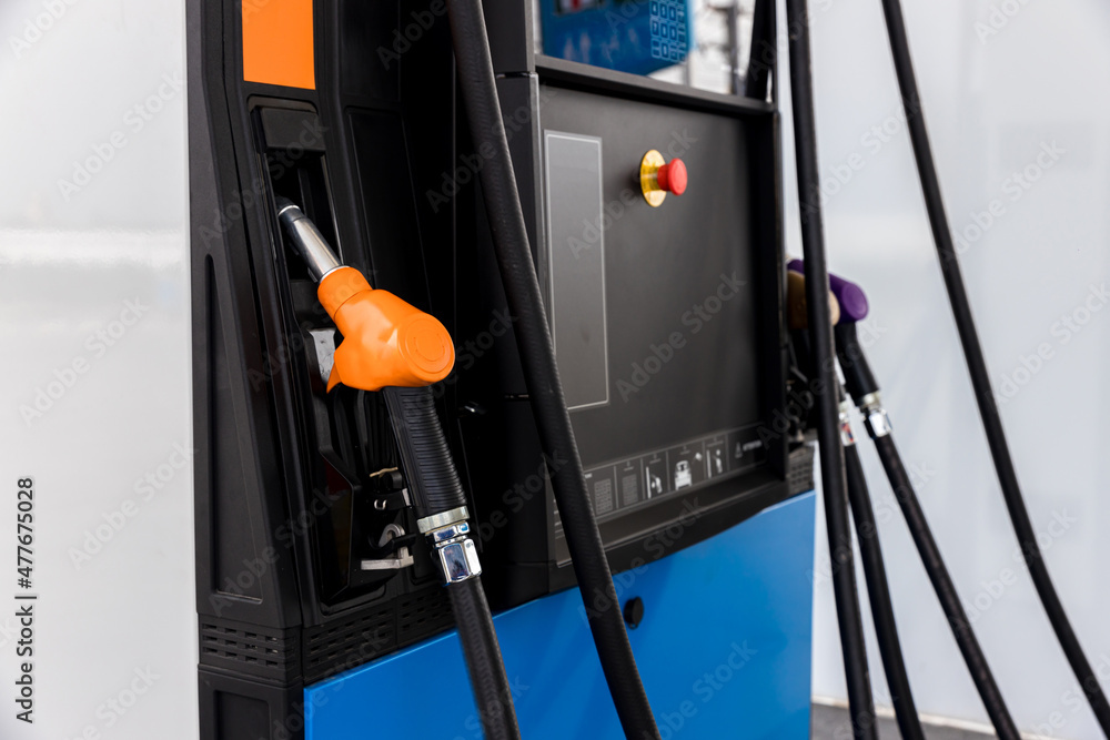 Fuel Pump, Gas Station, Gasoline. Colorful Petrol pump filling nozzles . Gas station in a service Head fuel vehicle refueling facility