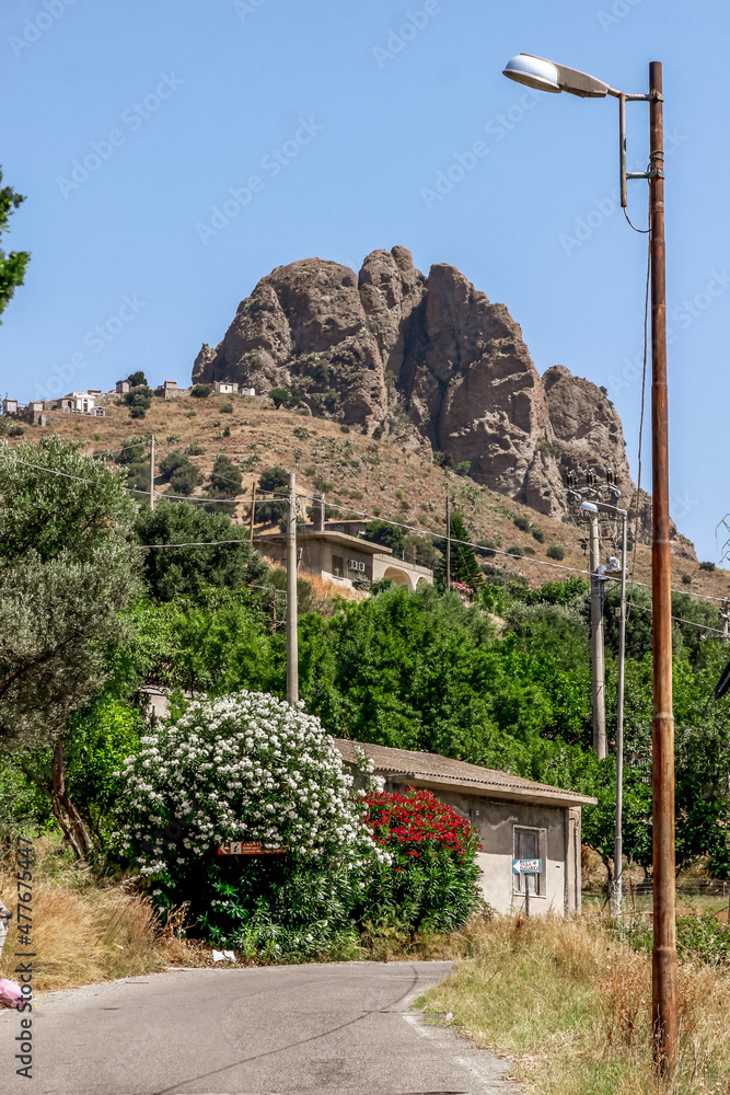 Obraz premium Small village of Pentedattilo, church and ruins of the abandoned village, Greek colony on Mount Calvario, whose form recalls the five fingers. Calabria, Italy
