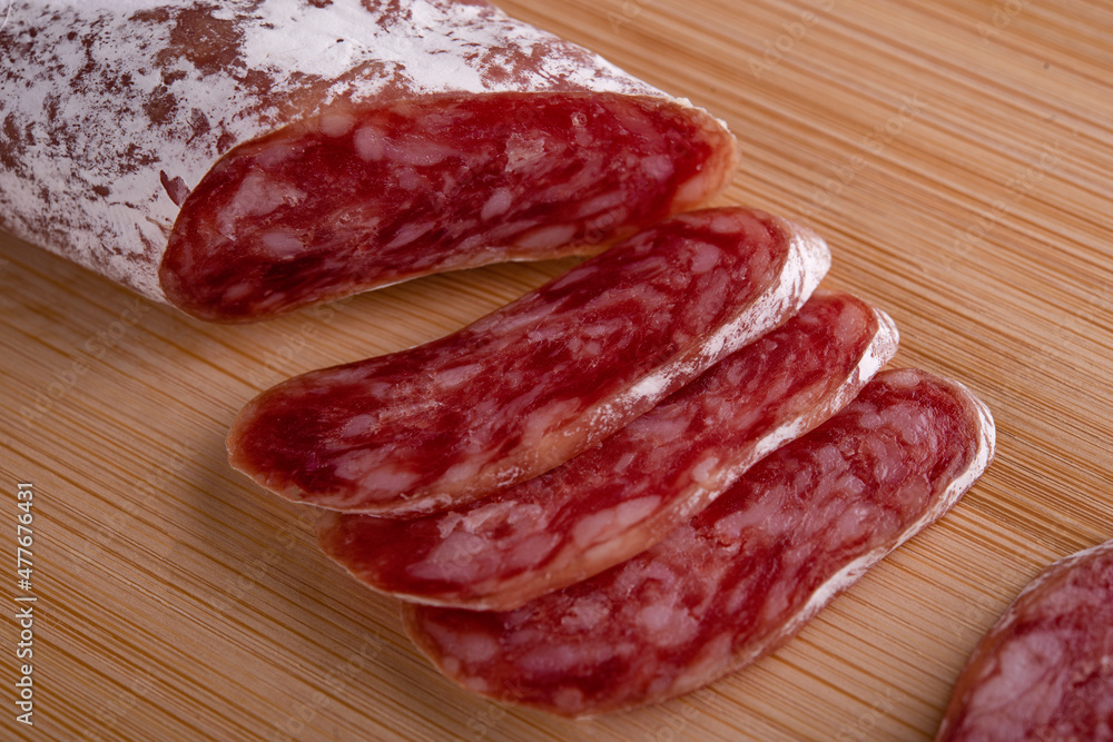sliced smoked sausage on a wooden board sliced smoked sausage on a wooden board