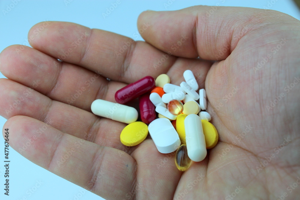 hand holding pills hand holding pills