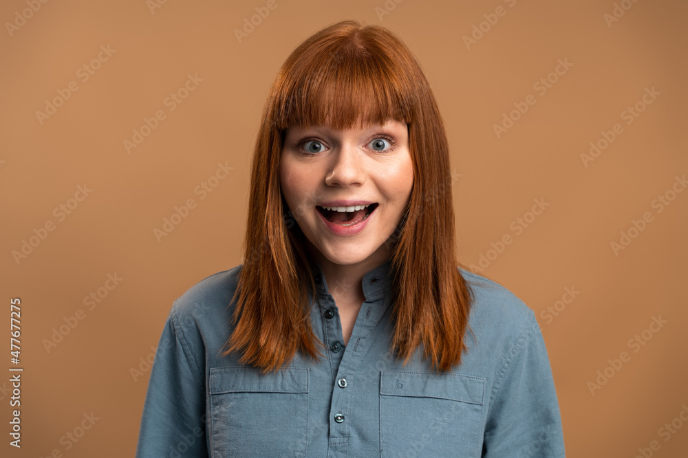 Surprised woman looking at camera with mouth open in amazement, expressing shock, astonishment Surprised woman looking at camera with mouth open in amazement, expressing shock, astonishment