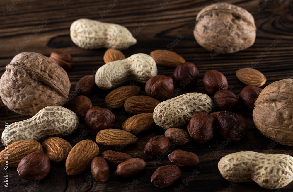Appetizing and useful different nuts on a wooden background Appetizing and useful different nuts on a wooden background