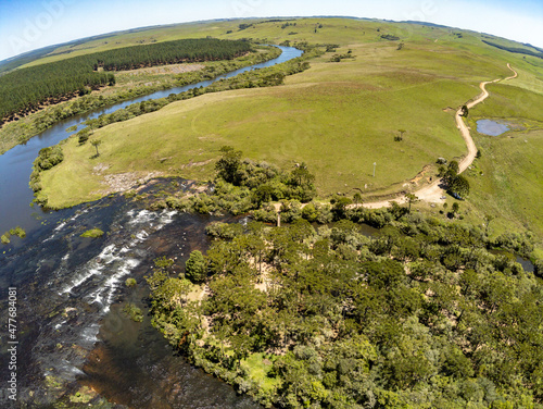 Aerial view of river, fields, forest and dirty road photo