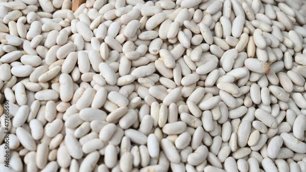 White beans for sale at vegetable market, close up. Boxes full of raw beans in shop. Organic bean at the greengrocer's stall. Vegetable. White beans for sale at vegetable market, close up. Boxes full of raw beans in shop. Organic bean at the greengrocer's stall. Vegetable.