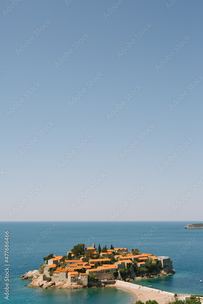 Sveti Stefan Island against a blue sky in the Bay of Kotor