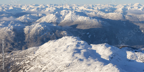 Aerial View from an Airplane of Whistler Mountain covered in fresh snow during winter season. British Columbia, Canada. Canadian Nature Landscape Background