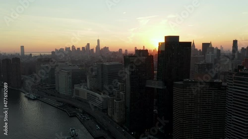 Wallpaper Mural Aerial view of buildings on waterfront. Downtown skyscrapers in distance. Shot against sunset. Manhattan, New York City, USA Torontodigital.ca