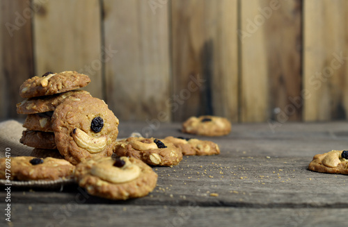 Cookies stack with cashews and Raisins with old wood background