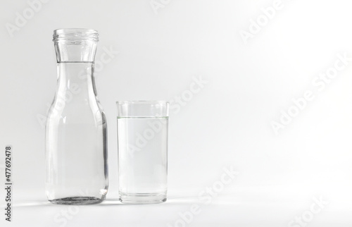 Water glass and bottle on a white background