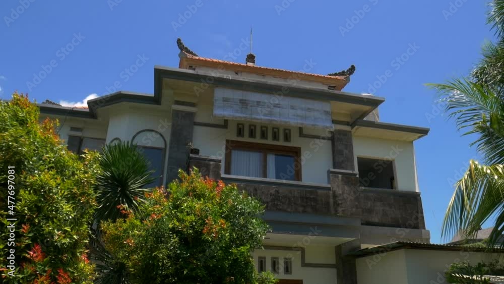 House in bali with lush green trees around it House in bali with lush green trees around it