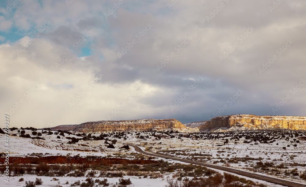 Hazardous winter weather along a high rocky mountains on I-40 highway with winter snow covered landscape in the New Mexico