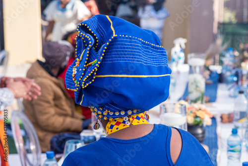 Rear view of African woman with colorful headdress on photo