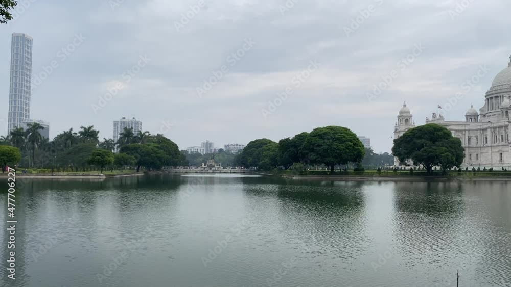 Slow motion wide view of the beautiful Victoria Memorial House, In the memory of Queen Victoria. The Beautiful marble building built by Britishers in front of the lake in Kolkata. Slow motion wide view of the beautiful Victoria Memorial House, In the memory of Queen Victoria. The Beautiful marble building built by Britishers in front of the lake in Kolkata.