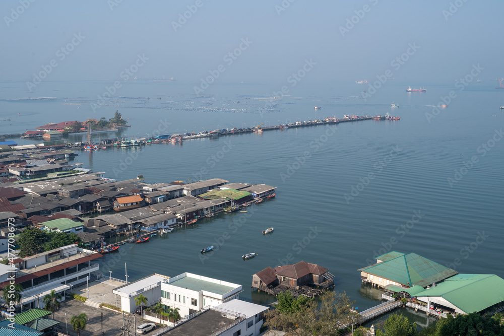 Aerial view of Sriracha waterfront and pier showing floating buildings and small boats on a bright day