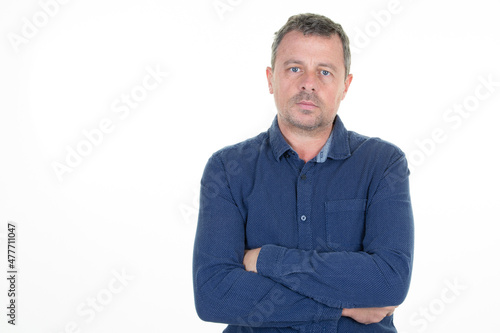 handsome middle aged man folded arms crossed on white background © OceanProd