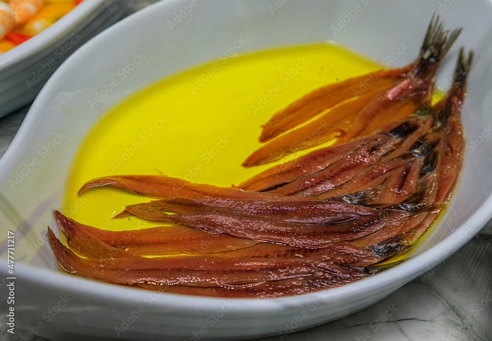 Fototapeta premium Spanish pintxos of anchovies in vinegar in a Basque bar in San Sebastian, Spain